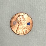 photo of ear tube on penny